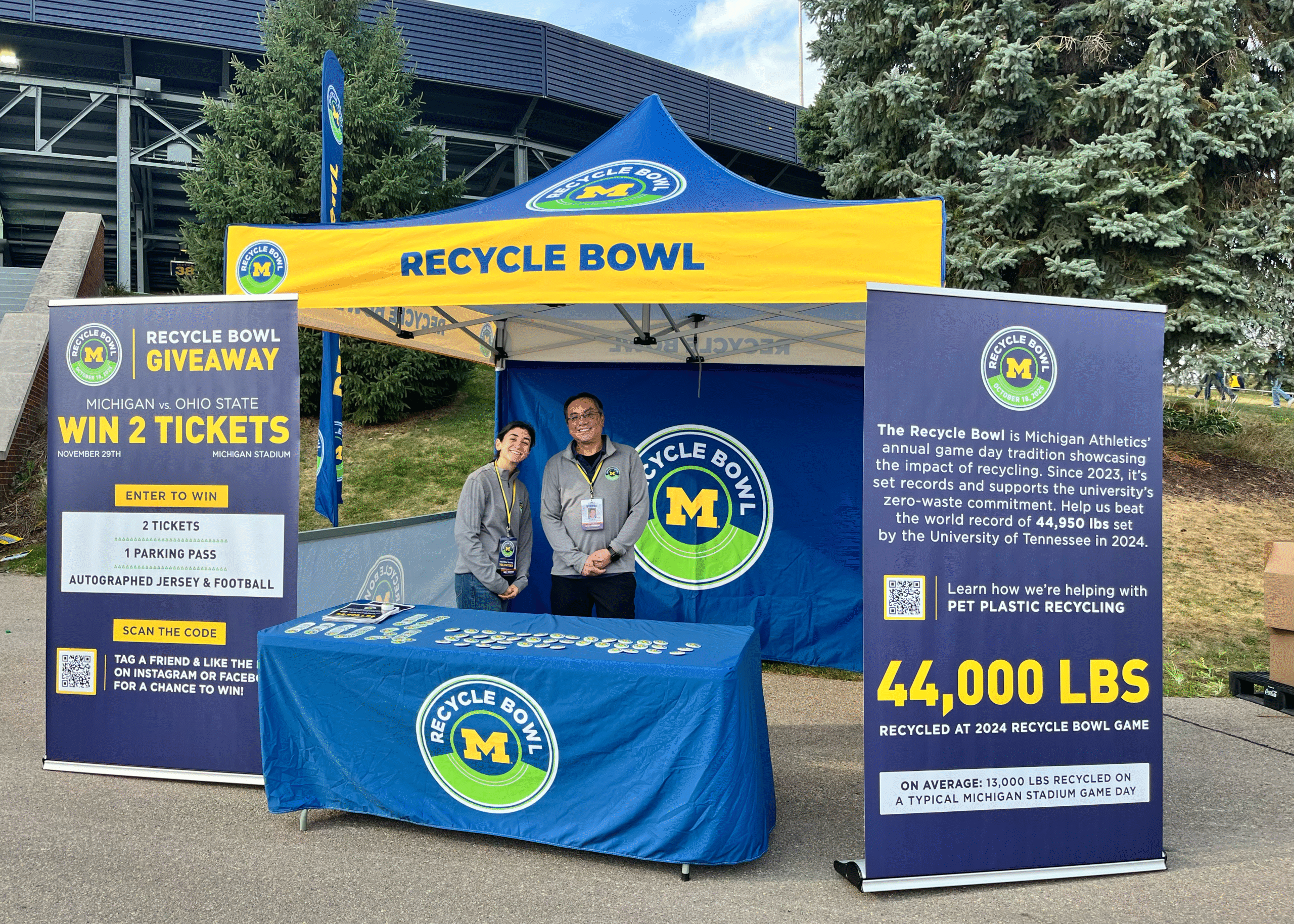 University of Michigan Recycle Bowl information booth at Fan Fest, where volunteers educate football fans about PET bottle recycling, game-day sustainability, and the annual Recycle Bowl.
