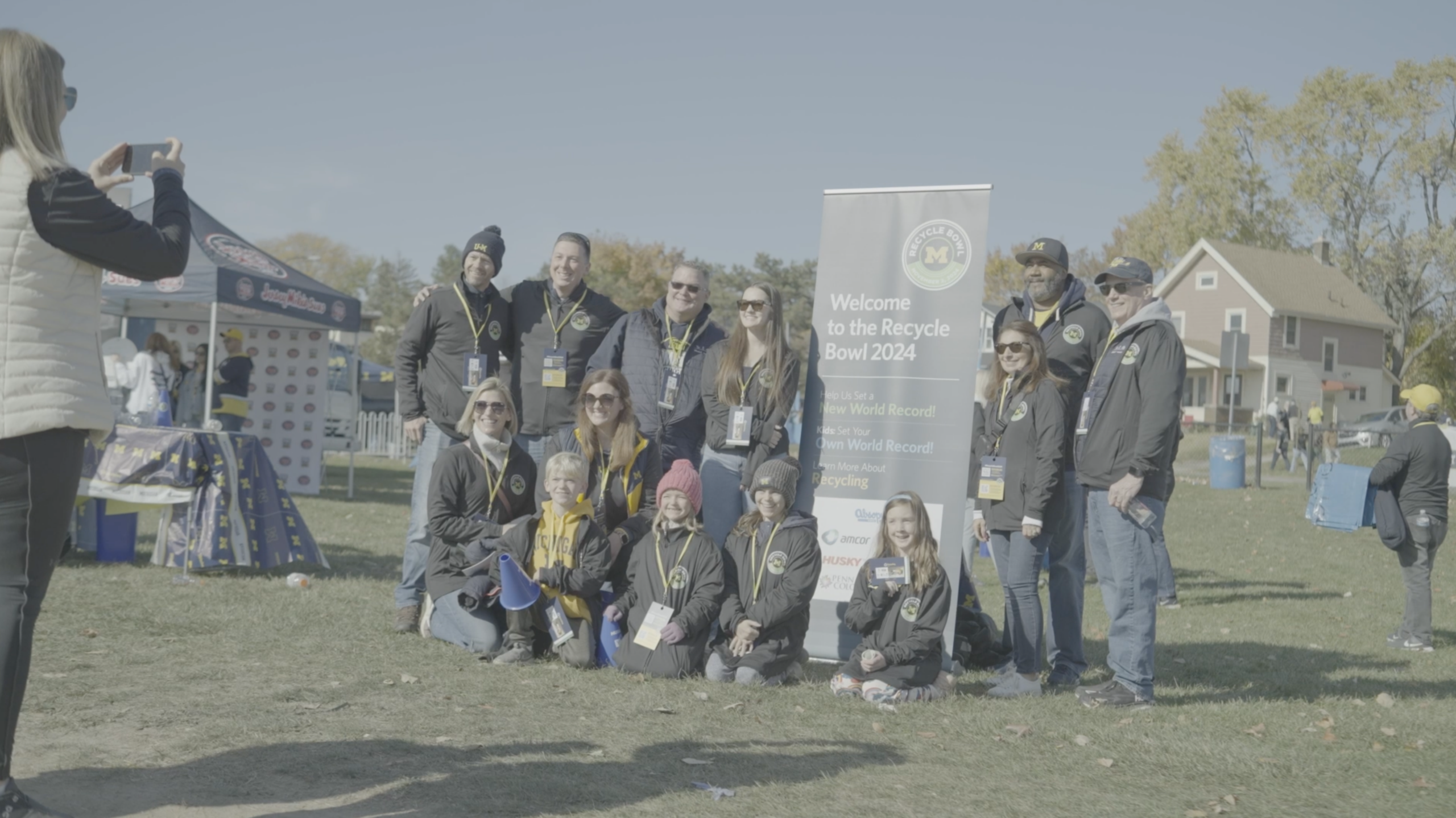 Recycle Bowl volunteers gather for a kickoff photo before the University of Michigan football game, celebrating PET bottle recycling and game-day sustainability.